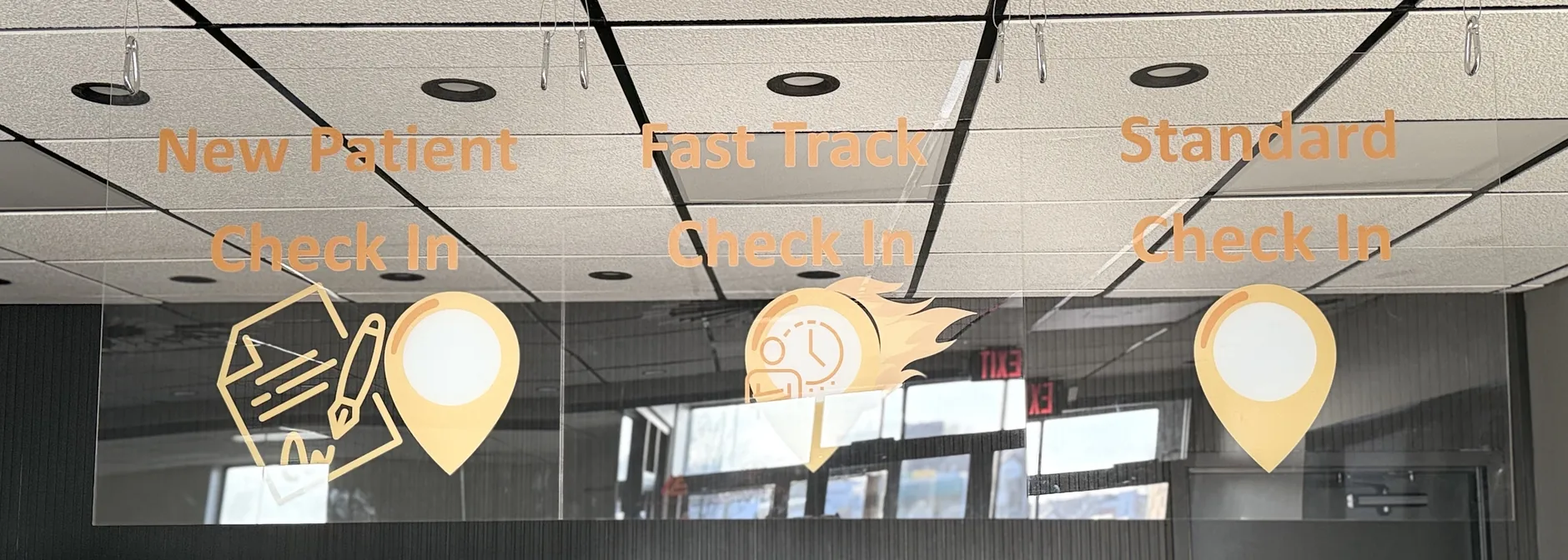 New Patient, Fast Track and Standard check-in lanes above the front desk at Express Urgent Care, 4479 Woodson Rd, Suite 290, St. Louis, Missouri